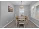 Cozy dining room with chandelier lighting, plantation shutters, and stylish wood-look flooring at 2670 E Bellerive Dr, Gilbert, AZ 85298