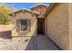Inviting front entrance of home with a quaint desert rock garden and covered doorway at 2670 E Bellerive Dr, Gilbert, AZ 85298