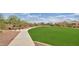 Scenic view of a community green space with walking path and picnic tables at 2670 E Bellerive Dr, Gilbert, AZ 85298