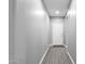 Well-lit hallway featuring wood-look flooring and a neutral color scheme at 2670 E Bellerive Dr, Gilbert, AZ 85298