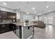 Open floorplan kitchen features stainless steel appliances, granite countertops, island, and flows into the living area at 2670 E Bellerive Dr, Gilbert, AZ 85298