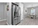 Stainless steel refrigerator in a well-lit kitchen next to an adjacent dining room at 2670 E Bellerive Dr, Gilbert, AZ 85298