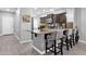 Kitchen island with granite countertop, seating, stainless steel appliances and tile backsplash, provides ample space at 2670 E Bellerive Dr, Gilbert, AZ 85298