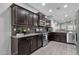 Modern kitchen with dark cabinetry, granite countertops, and stainless steel appliances at 2670 E Bellerive Dr, Gilbert, AZ 85298