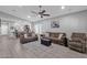 Open concept living room showcasing seamless flow with kitchen and comfortable seating arrangement with area rug at 2670 E Bellerive Dr, Gilbert, AZ 85298
