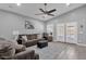 Spacious living room features ceiling fan, high ceilings, wood-look tile floors, and french doors to the patio at 2670 E Bellerive Dr, Gilbert, AZ 85298