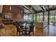 Open lounge features wood floors, media center, comfortable seating, and views of the lush outdoor landscaping at 2670 E Bellerive Dr, Gilbert, AZ 85298