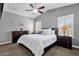 Spacious main bedroom features ceiling fan, carpet floors, picture windows, plantation shutters and bedside tables at 2670 E Bellerive Dr, Gilbert, AZ 85298