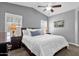Cozy main bedroom features ceiling fan, carpet floors, picture windows, plantation shutters and bedside lamps at 2670 E Bellerive Dr, Gilbert, AZ 85298
