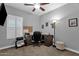 Functional office featuring a ceiling fan, a desk, and a shuttered window at 2670 E Bellerive Dr, Gilbert, AZ 85298
