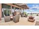 Outdoor seating and fireplace area with beautiful views of the pond and surrounding community at 2670 E Bellerive Dr, Gilbert, AZ 85298