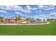 Community playground featuring colorful climbing structures and lush green grass at 2670 E Bellerive Dr, Gilbert, AZ 85298
