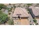 Bird's eye view of a desert home with a tile roof, two-car garage, and desert landscaping at 26774 W Firehawk Dr, Buckeye, AZ 85396