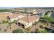 Aerial view of the property featuring a covered patio, desert landscaping, and a tile roof at 26774 W Firehawk Dr, Buckeye, AZ 85396