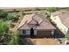 Aerial view of a desert home showcasing its well-maintained tile roof and desert landscaping at 26774 W Firehawk Dr, Buckeye, AZ 85396