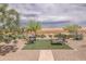 Scenic backyard featuring desert landscaping, a small artificial turf area, and outdoor seating at 26774 W Firehawk Dr, Buckeye, AZ 85396