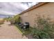 The backyard features a small seating area on artificial turf with desert landscaping at 26774 W Firehawk Dr, Buckeye, AZ 85396