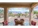 Relaxing covered patio with views of the landscaped backyard at 26774 W Firehawk Dr, Buckeye, AZ 85396