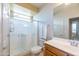 Bathroom with a glass-enclosed shower and oak vanity at 26774 W Firehawk Dr, Buckeye, AZ 85396