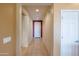 Bright hallway with tiled floors, recessed lighting, and neutral paint, connecting the rooms at 26774 W Firehawk Dr, Buckeye, AZ 85396