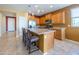 Beautiful island kitchen with granite countertops, pendant lighting, and stainless steel appliances at 26774 W Firehawk Dr, Buckeye, AZ 85396