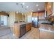 Bright kitchen boasts granite countertops, stainless appliances, tile floors, and a convenient island at 26774 W Firehawk Dr, Buckeye, AZ 85396