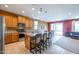 Bright kitchen with an island, stainless steel appliances, and adjacent living area, great for entertaining at 26774 W Firehawk Dr, Buckeye, AZ 85396