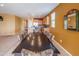 Open-concept kitchen and dining area featuring tiled floors and warm, inviting wall colors at 26774 W Firehawk Dr, Buckeye, AZ 85396