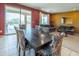 Cozy living area featuring comfortable sofas, a dining table, and sliding glass doors to the outdoors at 26774 W Firehawk Dr, Buckeye, AZ 85396