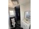 Modern bathroom featuring a black tiled shower and white vanity at 2831 W Montecito Ave, Phoenix, AZ 85017