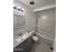 Updated bathroom features a modern vanity with granite countertop and tub with tile surround at 2831 W Montecito Ave, Phoenix, AZ 85017