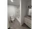 Renovated bathroom featuring a modern vanity, and a tiled shower with a glass door at 2831 W Montecito Ave, Phoenix, AZ 85017