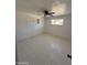 This bedroom features tile flooring, a ceiling fan and a built-in shelving unit at 2831 W Montecito Ave, Phoenix, AZ 85017