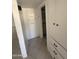 Hallway featuring built-in white cabinets, shelving and tile flooring at 2831 W Montecito Ave, Phoenix, AZ 85017