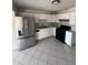 Bright kitchen features modern stainless steel appliances and white cabinetry at 2831 W Montecito Ave, Phoenix, AZ 85017
