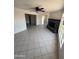 Open-concept living room with tile flooring and a brick fireplace at 2831 W Montecito Ave, Phoenix, AZ 85017