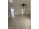 Open-concept living room boasts tile flooring, ceiling fan, and neutral color palette at 2831 W Montecito Ave, Phoenix, AZ 85017