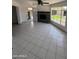 Open-concept living room with tile flooring and a brick fireplace at 2831 W Montecito Ave, Phoenix, AZ 85017