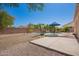 Backyard featuring a pool, rock waterfall, and outdoor seating area under a blue umbrella at 3059 E Parkview Dr, Gilbert, AZ 85295
