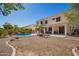 Backyard featuring a pool, patio, landscaping, and a two-story home with a covered patio at 3059 E Parkview Dr, Gilbert, AZ 85295