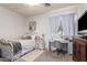 This is a cozy bedroom featuring a twin bed, a dedicated workspace, and ample natural light for a comfortable retreat at 3059 E Parkview Dr, Gilbert, AZ 85295