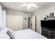 Bedroom featuring a ceiling fan, carpet, and a view into the bathroom at 3059 E Parkview Dr, Gilbert, AZ 85295