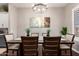 Dining room featuring an elegant chandelier, table with seating for six, and natural lighting from plantation shutters at 3059 E Parkview Dr, Gilbert, AZ 85295