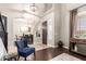 Inviting entryway with dark wood floors, featuring an elegant console table and a view into the dining area at 3059 E Parkview Dr, Gilbert, AZ 85295