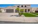 Charming two-story home with a well-manicured lawn, complemented by a spacious driveway and a three-car garage at 3059 E Parkview Dr, Gilbert, AZ 85295