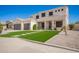 Two-story home featuring a well-manicured lawn with stepping stones, complemented by a spacious driveway and a three-car garage at 3059 E Parkview Dr, Gilbert, AZ 85295