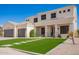 Two-story home featuring a well-manicured lawn with stepping stones, complemented by a spacious driveway and a three-car garage at 3059 E Parkview Dr, Gilbert, AZ 85295