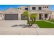 Charming two-story home with a well-manicured lawn, complemented by a spacious driveway and a three-car garage at 3059 E Parkview Dr, Gilbert, AZ 85295