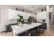Island kitchen featuring white quartz countertop, barstool seating, and stainless appliances at 3059 E Parkview Dr, Gilbert, AZ 85295