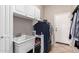 Laundry room with a utility sink, white cabinets, and a front load washer and dryer at 3059 E Parkview Dr, Gilbert, AZ 85295